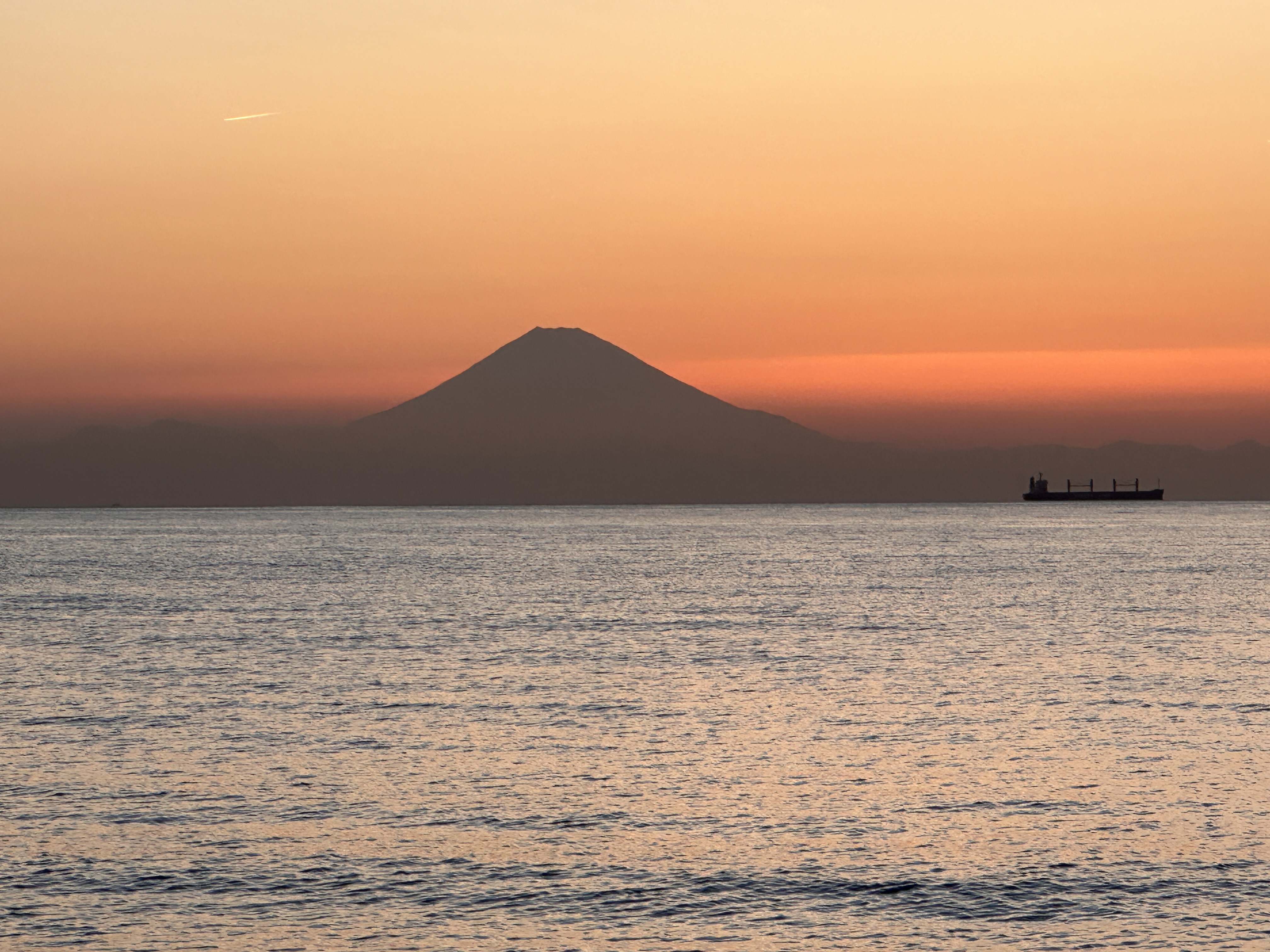 Mount Fuji at sunset across the water